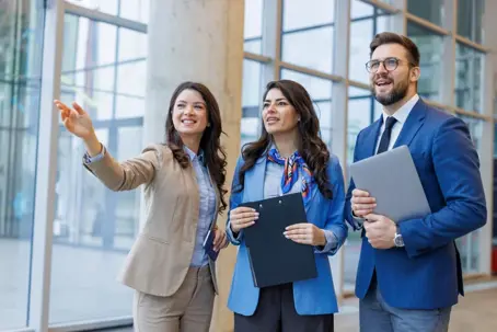 Business professionals discussing a new property showcasing the space and features