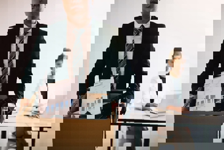 business man leaving with box of belongings