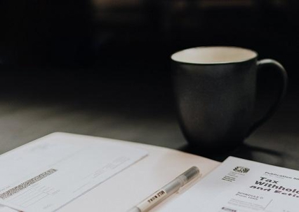 coffee mug and paperwork