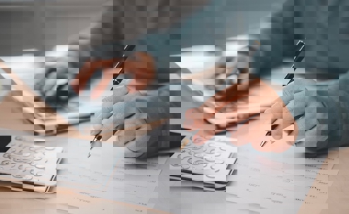 Calculator, Laptop and Writing Notes